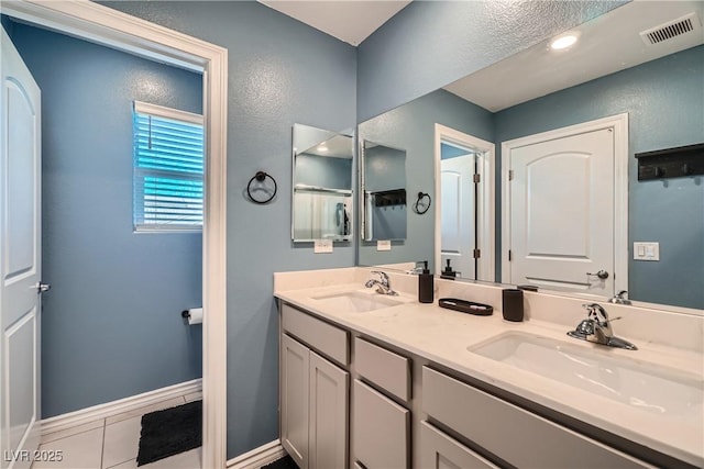 bathroom with vanity and tile patterned flooring