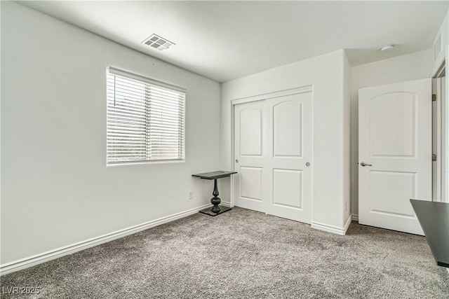 unfurnished bedroom with a closet and carpet flooring