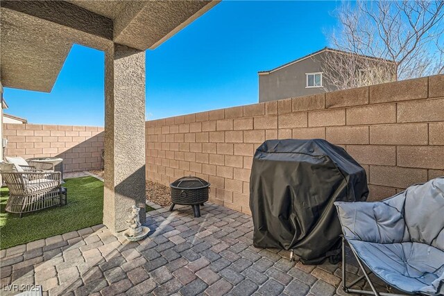 view of patio with a fire pit and grilling area