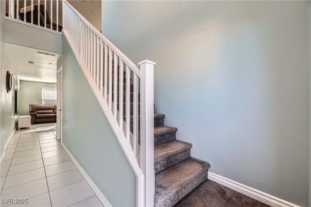 staircase featuring tile patterned floors