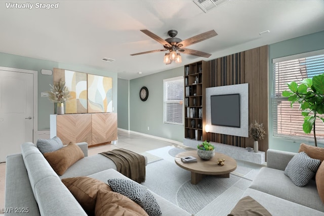 tiled living room with ceiling fan