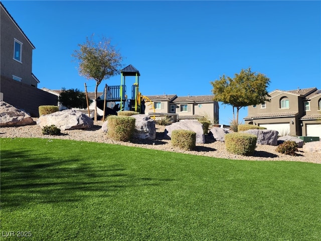 view of yard with a playground and a garage