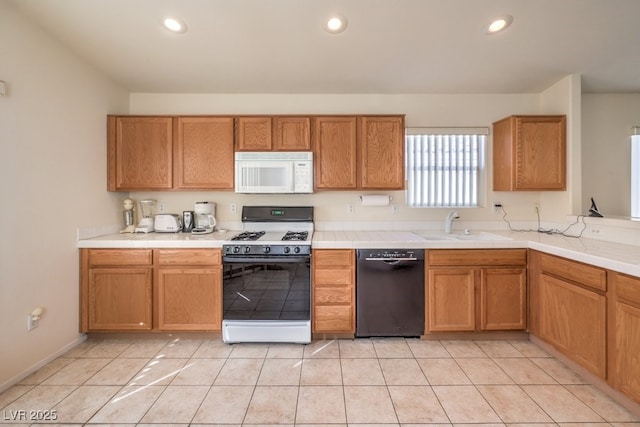 kitchen with light tile patterned floors, white appliances, and sink