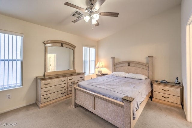 carpeted bedroom with ceiling fan, vaulted ceiling, and multiple windows