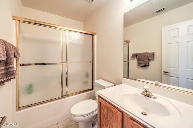 full bathroom with tile patterned flooring, vanity, toilet, and combined bath / shower with glass door