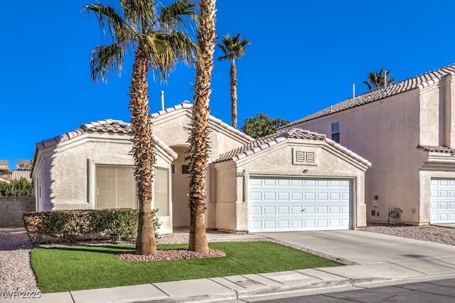 mediterranean / spanish-style home with a garage