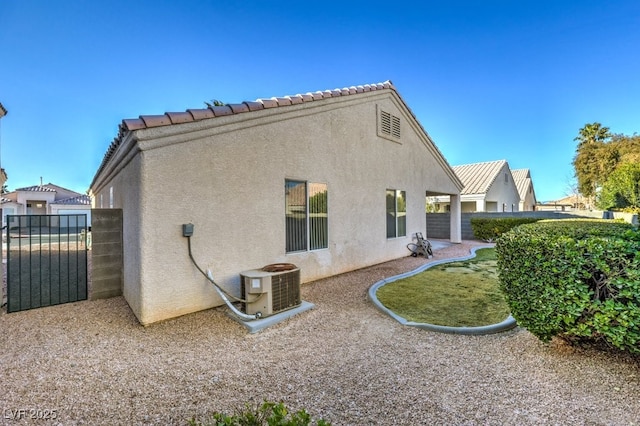 rear view of house featuring cooling unit