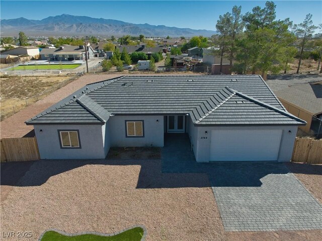 ranch-style house with a mountain view and a garage