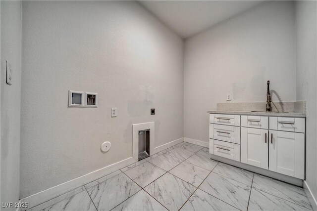 laundry room with hookup for an electric dryer, hookup for a gas dryer, cabinets, and sink