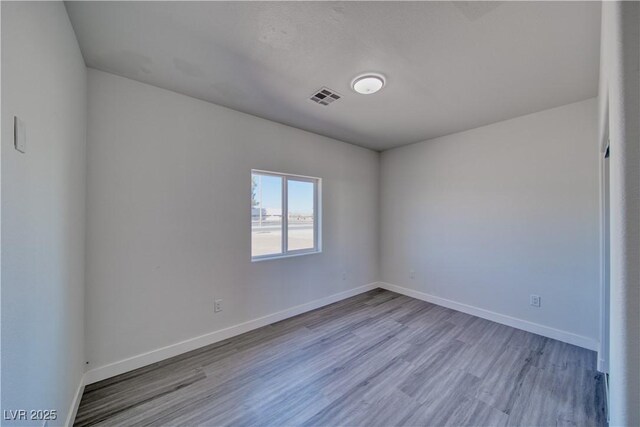 unfurnished room with light hardwood / wood-style flooring