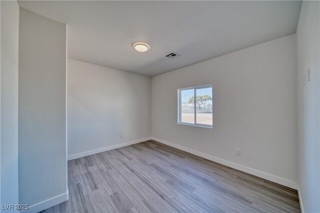 unfurnished room with light hardwood / wood-style flooring