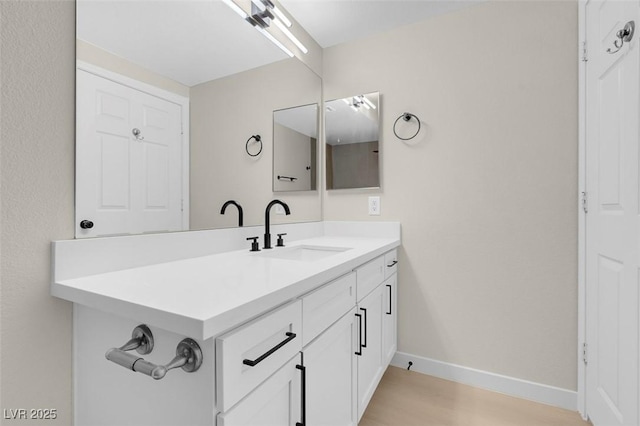 bathroom featuring wood-type flooring and vanity