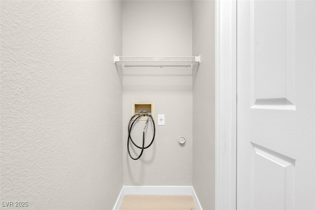 laundry room with washer hookup and hardwood / wood-style flooring