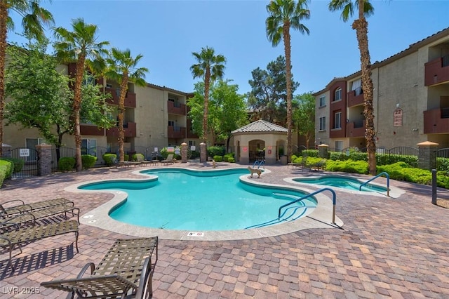 view of swimming pool featuring a gazebo, a patio, and a community hot tub