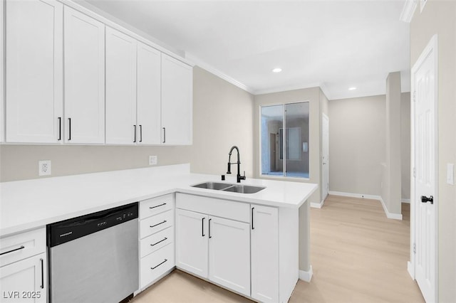 kitchen featuring white cabinets, dishwasher, and sink