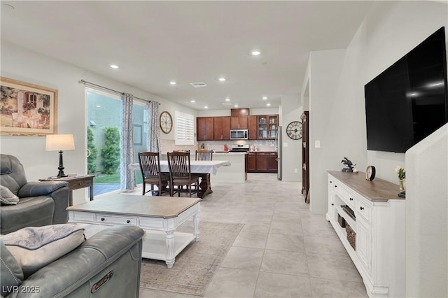 living room with light tile patterned floors and plenty of natural light