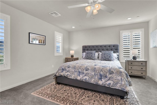 carpeted bedroom featuring ceiling fan and multiple windows