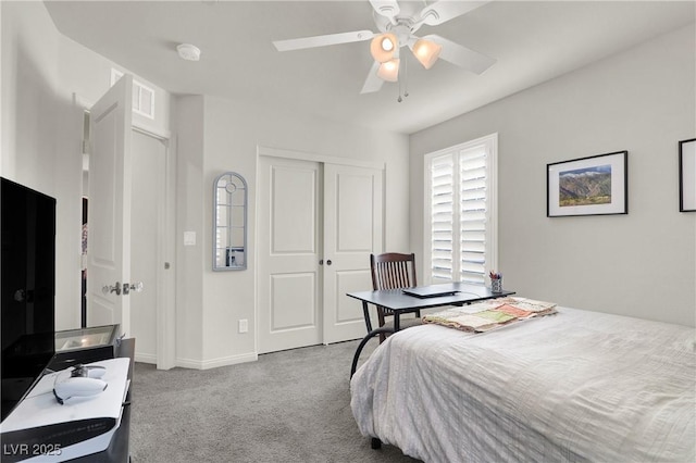 carpeted bedroom with ceiling fan and a closet