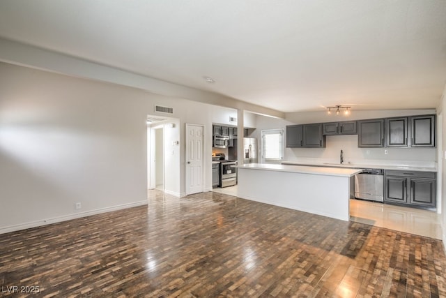 kitchen featuring a center island, light hardwood / wood-style floors, sink, and appliances with stainless steel finishes