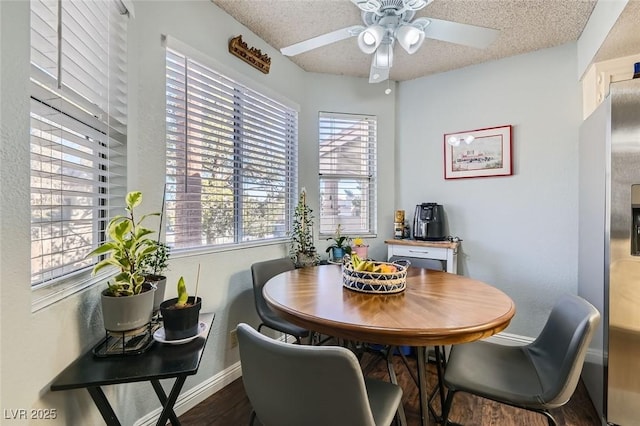 dining area with ceiling fan and a textured ceiling