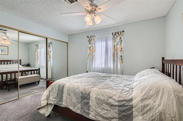 carpeted bedroom featuring ceiling fan, a textured ceiling, and a closet