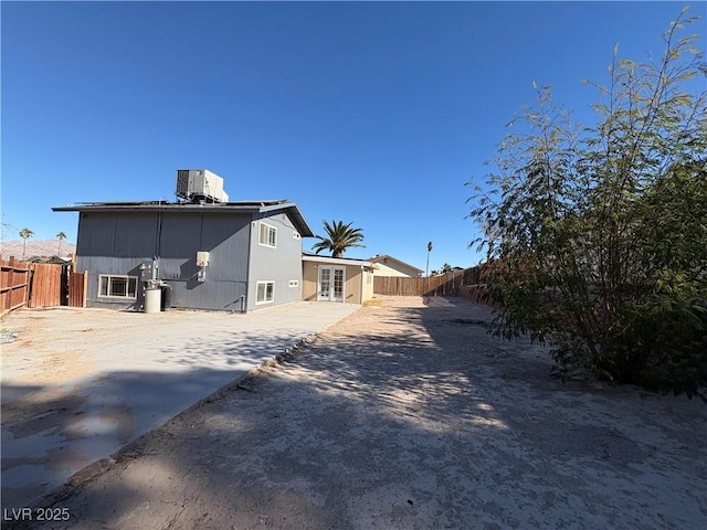 back of house with central AC unit and a patio area