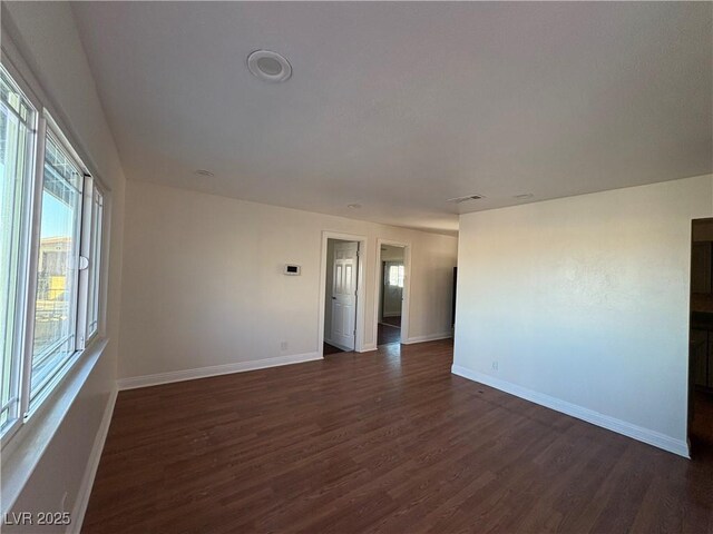 empty room featuring dark wood-type flooring