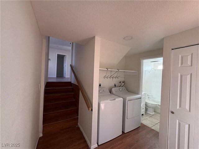 laundry area featuring dark hardwood / wood-style floors, independent washer and dryer, and a textured ceiling