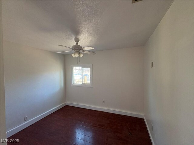 spare room featuring dark hardwood / wood-style floors, ceiling fan, and a textured ceiling