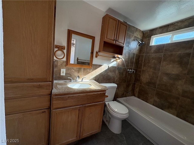 full bathroom featuring tile patterned flooring, toilet, decorative backsplash, vanity, and tiled shower / bath