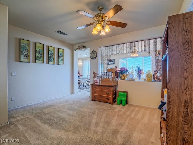 interior space featuring ceiling fan and light colored carpet