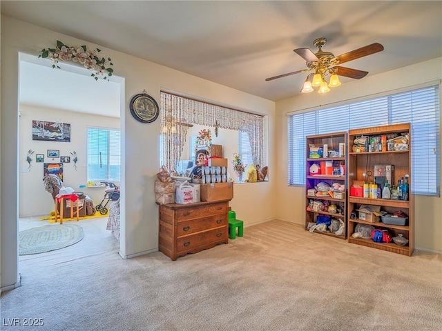 miscellaneous room featuring light colored carpet and ceiling fan