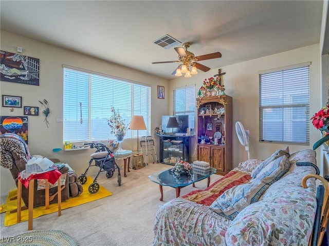 living room featuring carpet flooring and ceiling fan