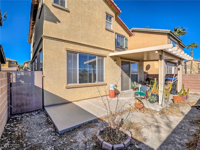 back of house with a patio