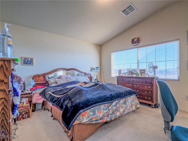 bedroom with light colored carpet and vaulted ceiling