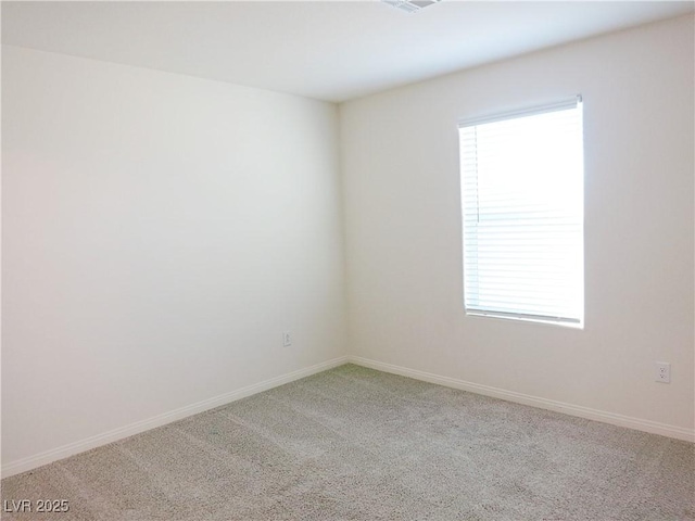 carpeted spare room featuring a healthy amount of sunlight