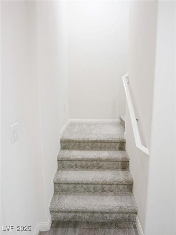 stairway featuring hardwood / wood-style floors