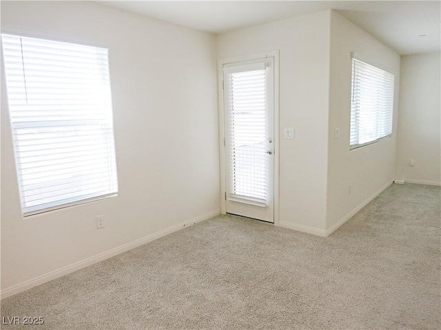 carpeted empty room with a healthy amount of sunlight