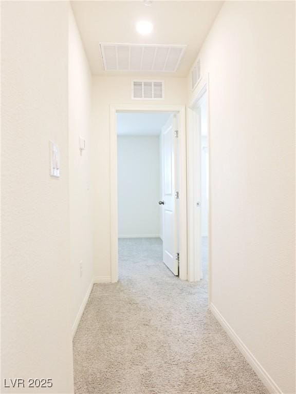 corridor featuring light colored carpet