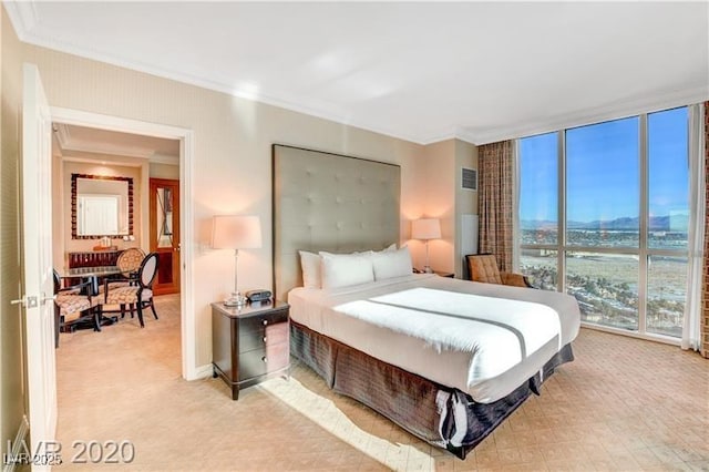 bedroom featuring floor to ceiling windows and ornamental molding