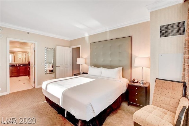 bedroom featuring connected bathroom and ornamental molding