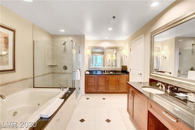 bathroom with tile patterned flooring, vanity, and independent shower and bath