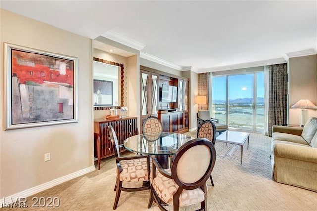 dining space with crown molding