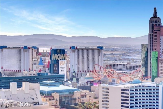 property's view of city featuring a mountain view