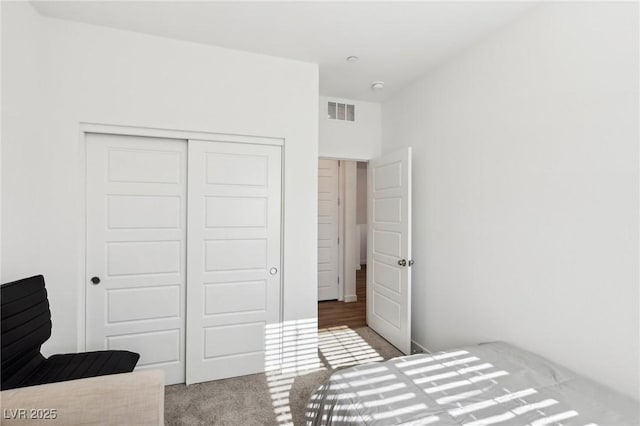 carpeted bedroom featuring a closet