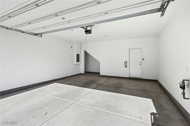 garage featuring electric panel and a garage door opener