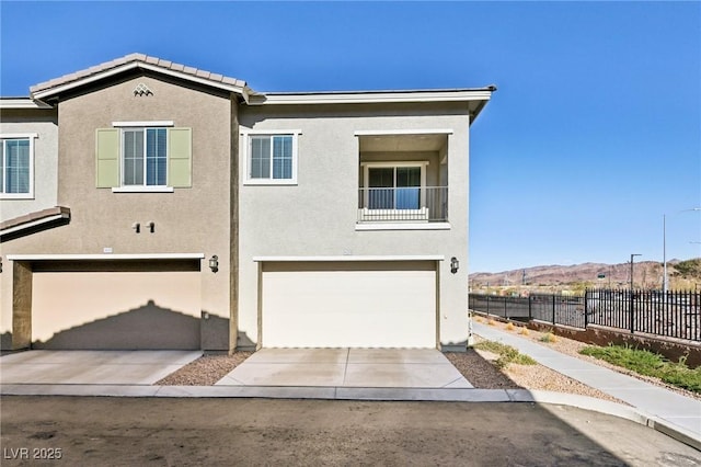 view of front of property with a mountain view and a garage