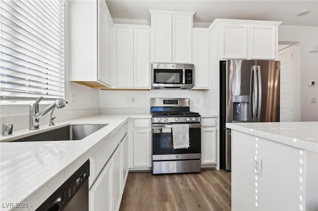 kitchen featuring white cabinetry, sink, and stainless steel appliances