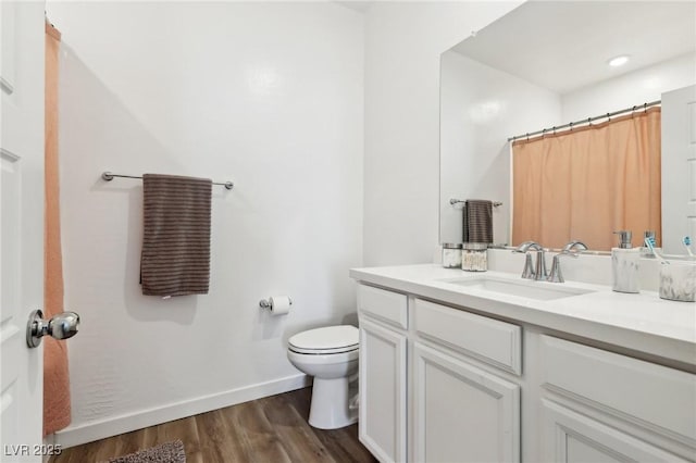 bathroom with hardwood / wood-style floors, vanity, toilet, and a shower with shower curtain