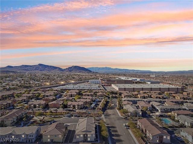 aerial view at dusk featuring a mountain view